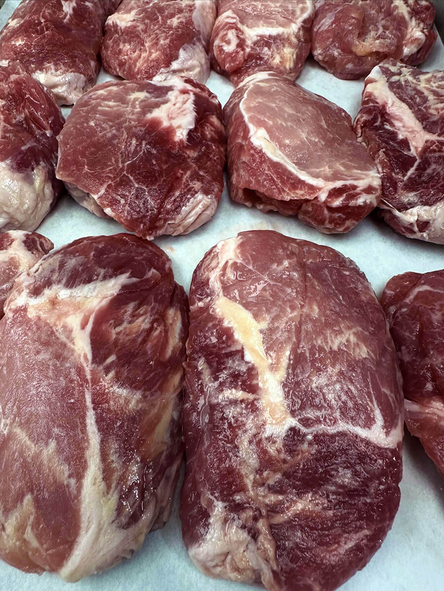 Thick-cut bone-in pork chops on butcher paper